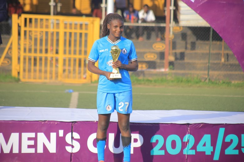 the woman in action and holding a winners cup